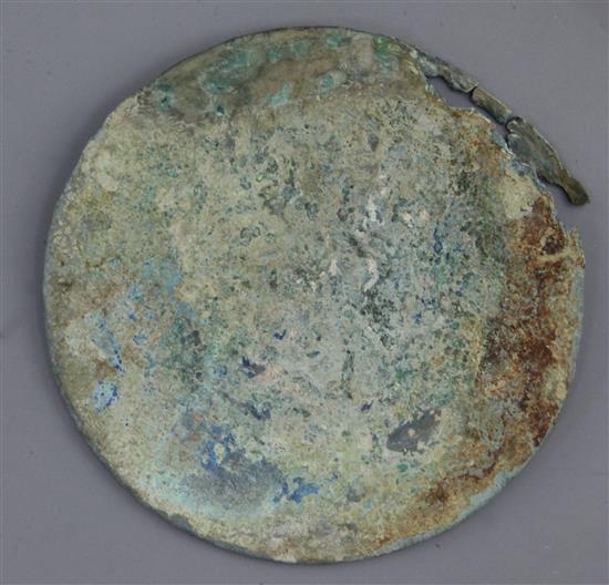 A Chinese bronze circular mirror, Eastern Zhou dynasty, 4th-3rd century B.C. 14cm diameter, damaged